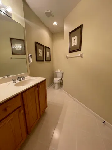 a spacious bathroom with a double vanity sink and a mirror