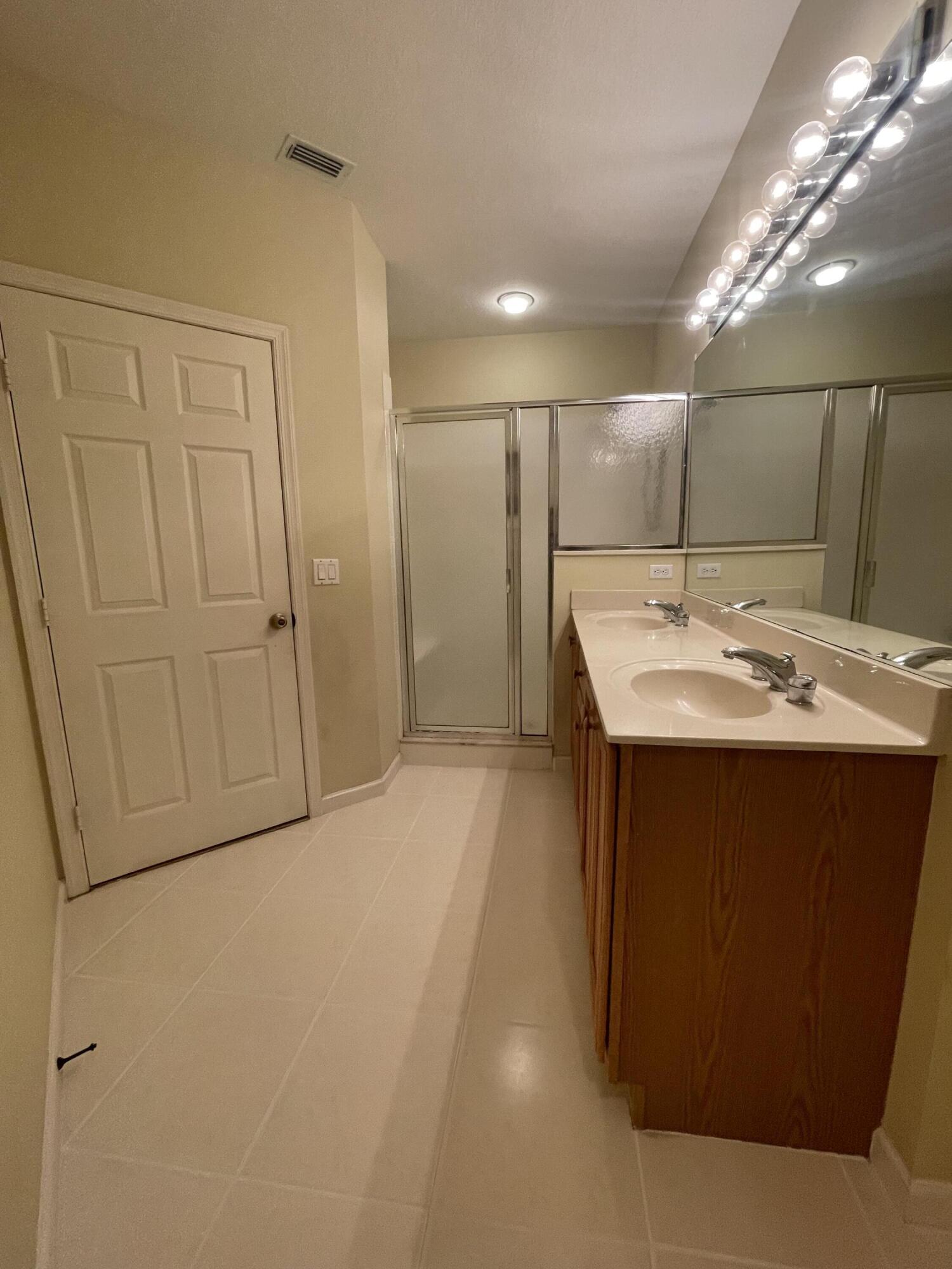 9125 Sand Shot Way, Unit A Port St. Lucie, FL 34986 - Photo 16 of 22 a room with a sink and a mirror