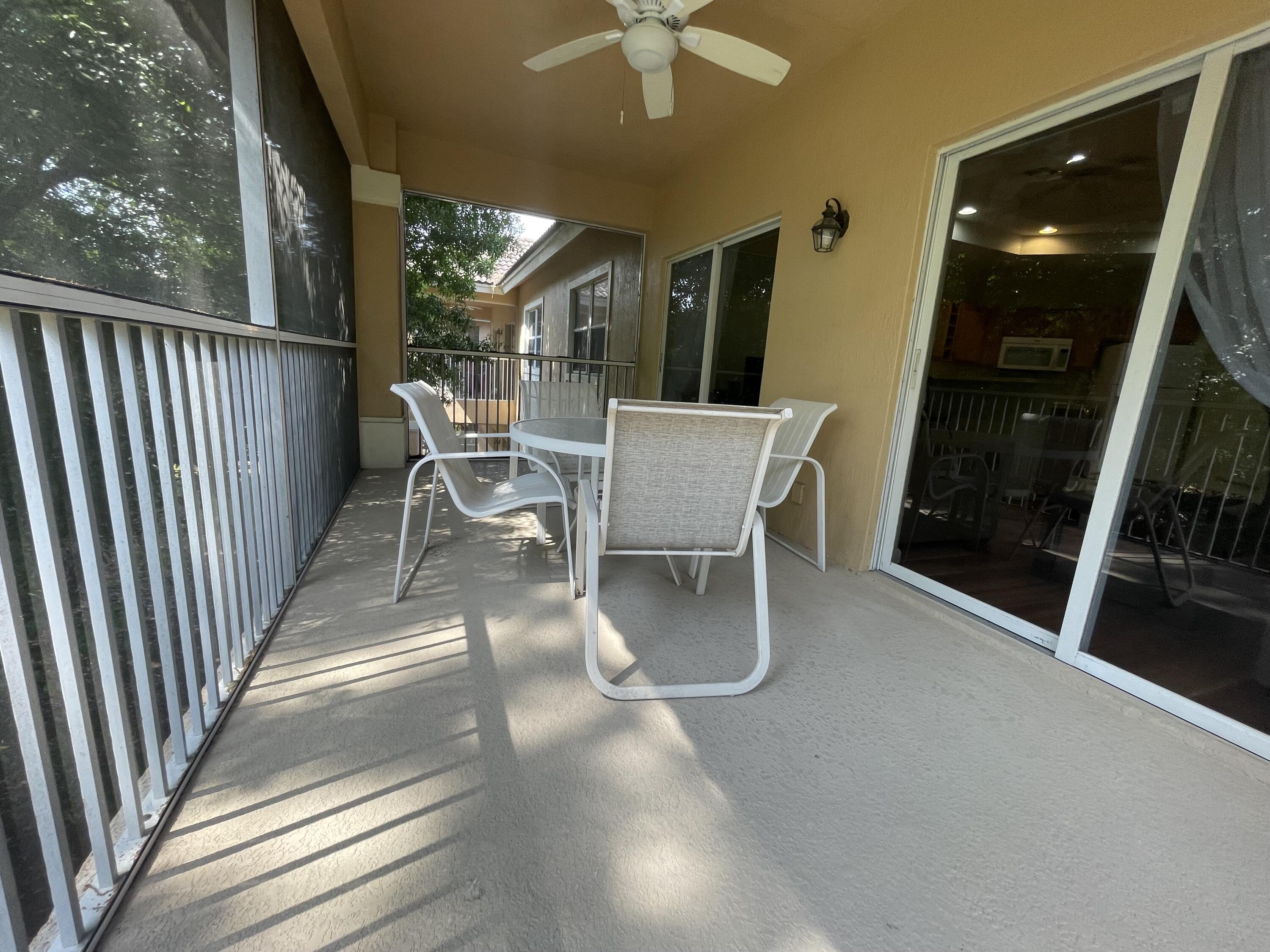 9125 Sand Shot Way, Unit A Port St. Lucie, FL 34986 - Photo 19 of 22 a view of a patio with table and chairs