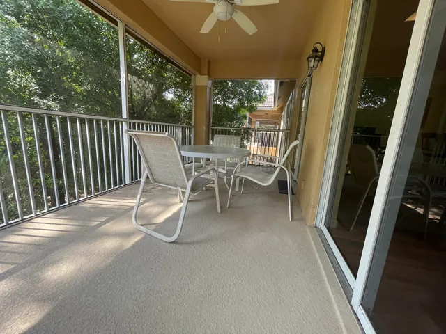a view of a patio with a table and chairs