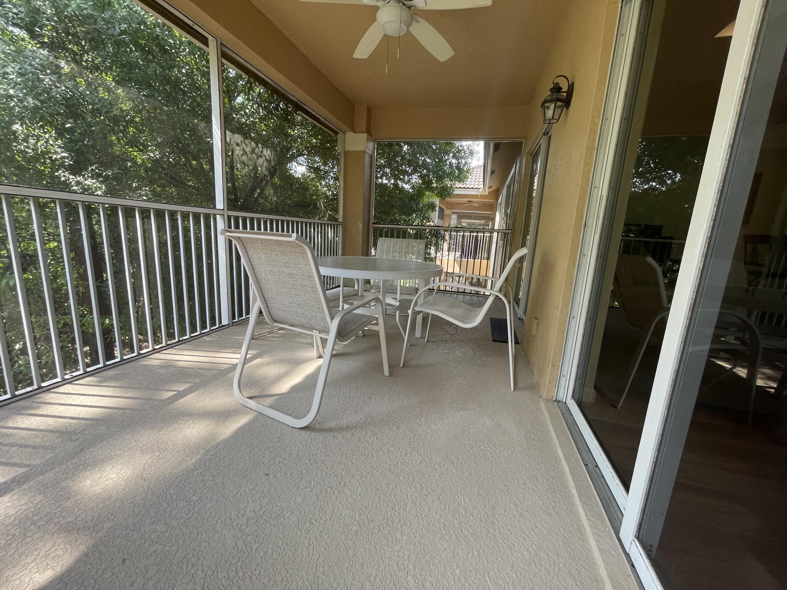 9125 Sand Shot Way, Unit A Port St. Lucie, FL 34986 - Photo 20 of 22 a view of a patio with a table and chairs