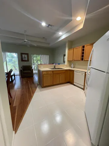 a kitchen with a refrigerator and a stove top oven