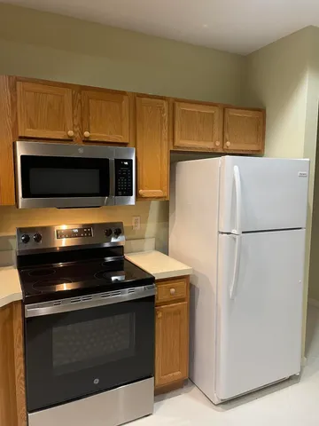 a kitchen with stainless steel appliances a stove a microwave and a refrigerator