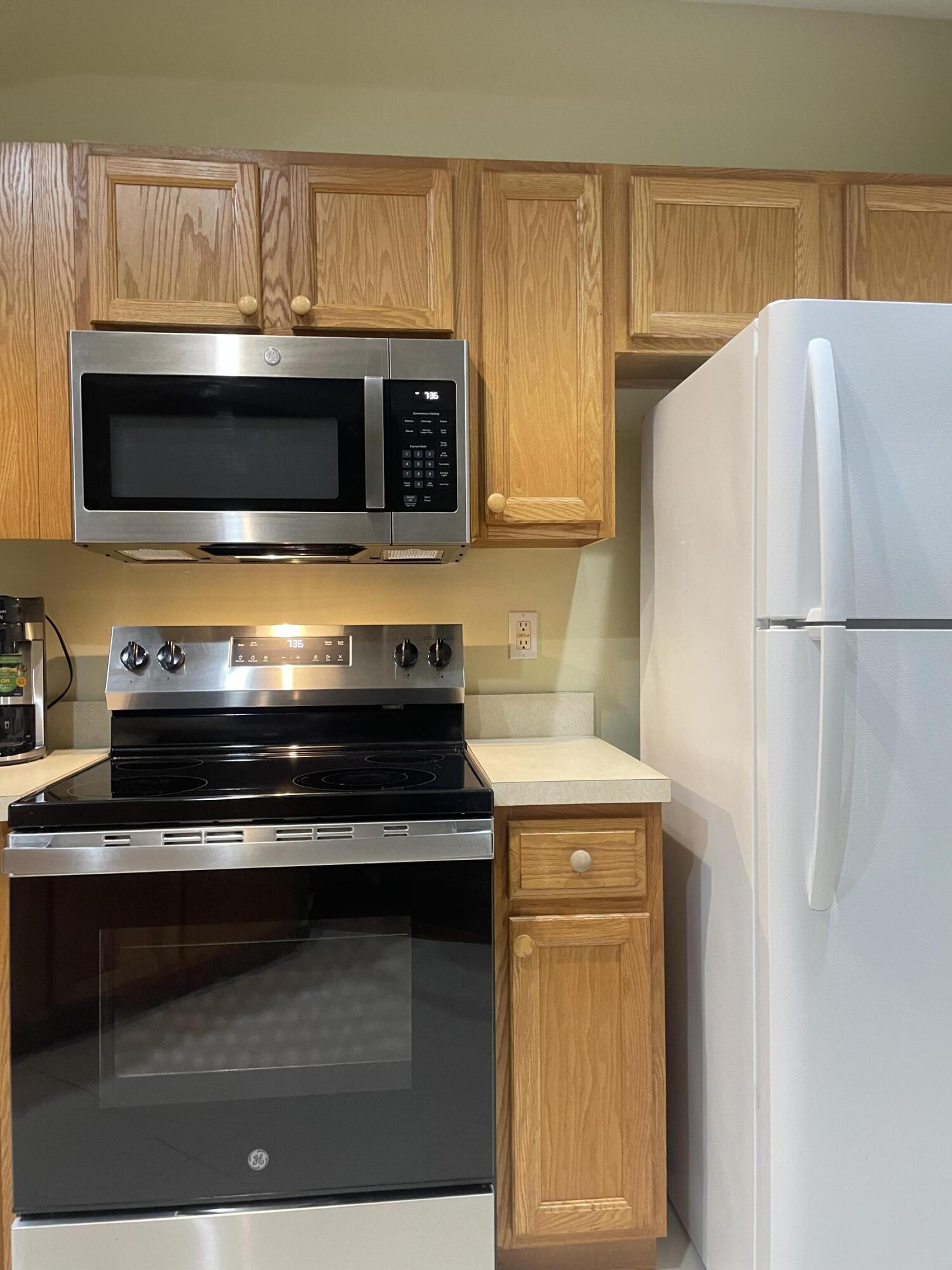 9125 Sand Shot Way, Unit A Port St. Lucie, FL 34986 - Photo 6 of 22 a kitchen with a stove and a microwave