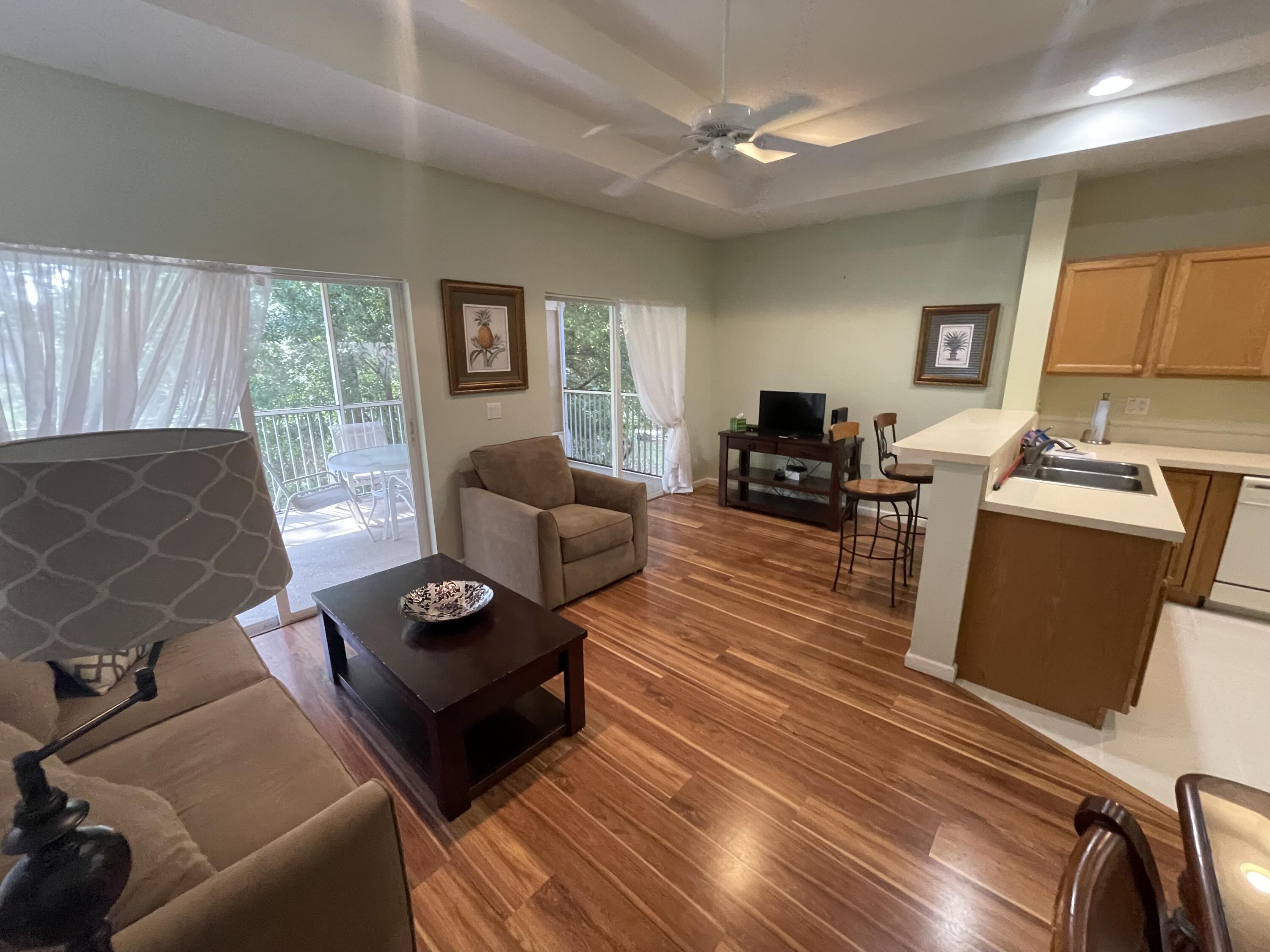 9125 Sand Shot Way, Unit A Port St. Lucie, FL 34986 - Photo 8 of 22 a living room with furniture and a flat screen tv
