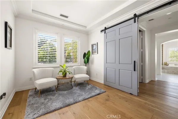 a view of a swimming pool with red chairs