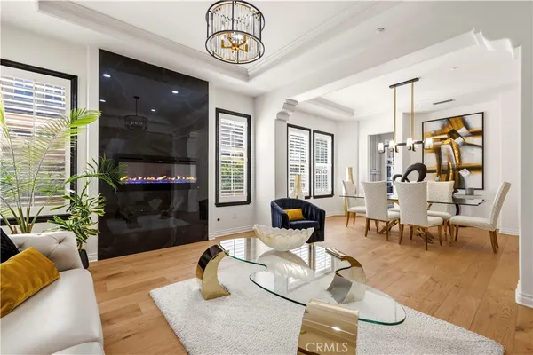 a living room with furniture a fireplace and a chandelier