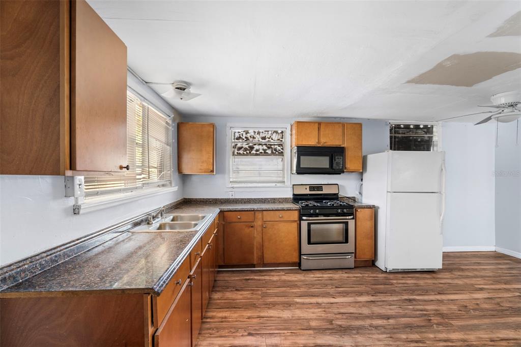2119 West Chestnut Street Tampa, FL 33607 - Photo 14 of 33 a kitchen with stainless steel appliances granite countertop a stove a sink and a microwave