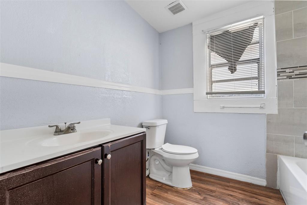 2119 West Chestnut Street Tampa, FL 33607 - Photo 20 of 33 a bathroom with a sink toilet and vanity