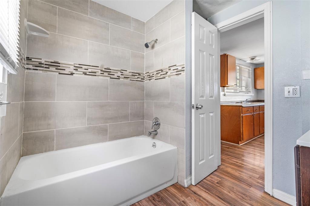 2119 West Chestnut Street Tampa, FL 33607 - Photo 21 of 33 a bathroom with a bathtub a shower and a sink