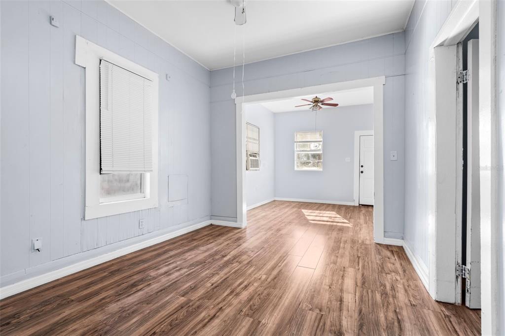 2119 West Chestnut Street Tampa, FL 33607 - Photo 8 of 33 an empty room with wooden floor and windows