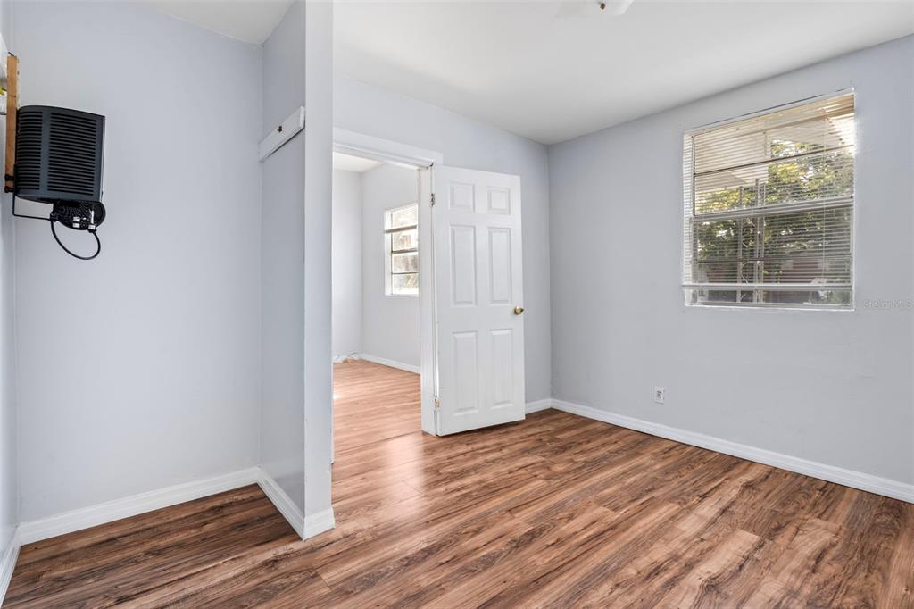 2119 West Chestnut Street Tampa, FL 33607 - Photo 10 of 33 an empty room with wooden floor and windows