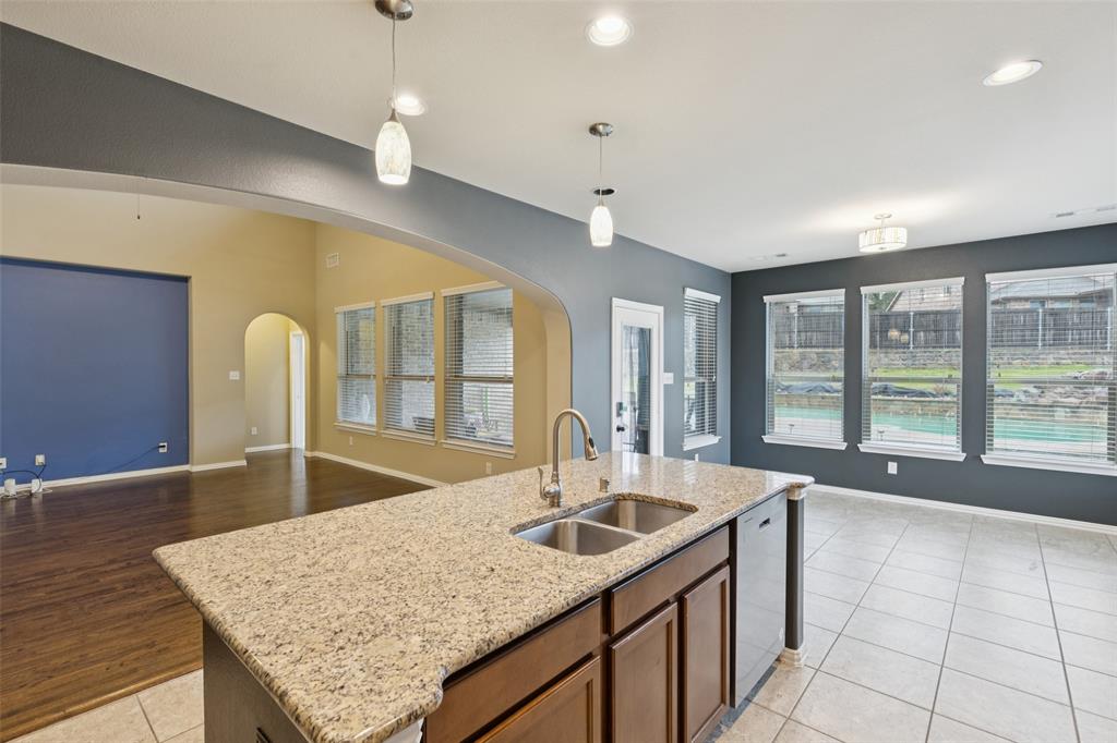6518 Dry Farm Rowlett, TX 75089 - Photo 13 of 40 a kitchen with granite countertop a sink and a window