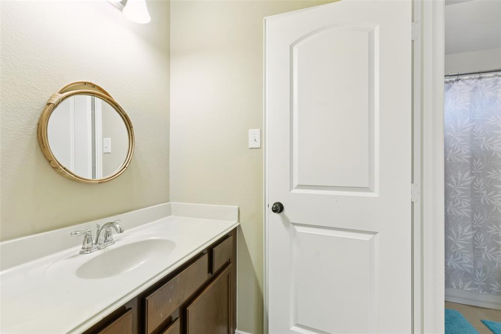 6518 Dry Farm Rowlett, TX 75089 - Photo 34 of 40 a bathroom with a sink and a mirror