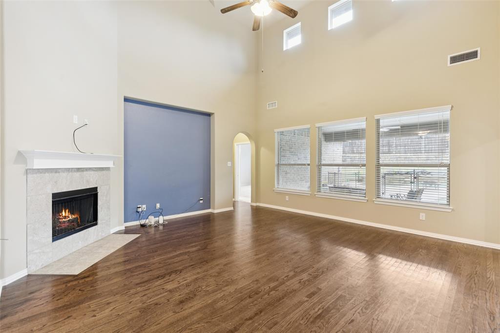 6518 Dry Farm Rowlett, TX 75089 - Photo 7 of 40 a view of an empty room with wooden floor fireplace and a window