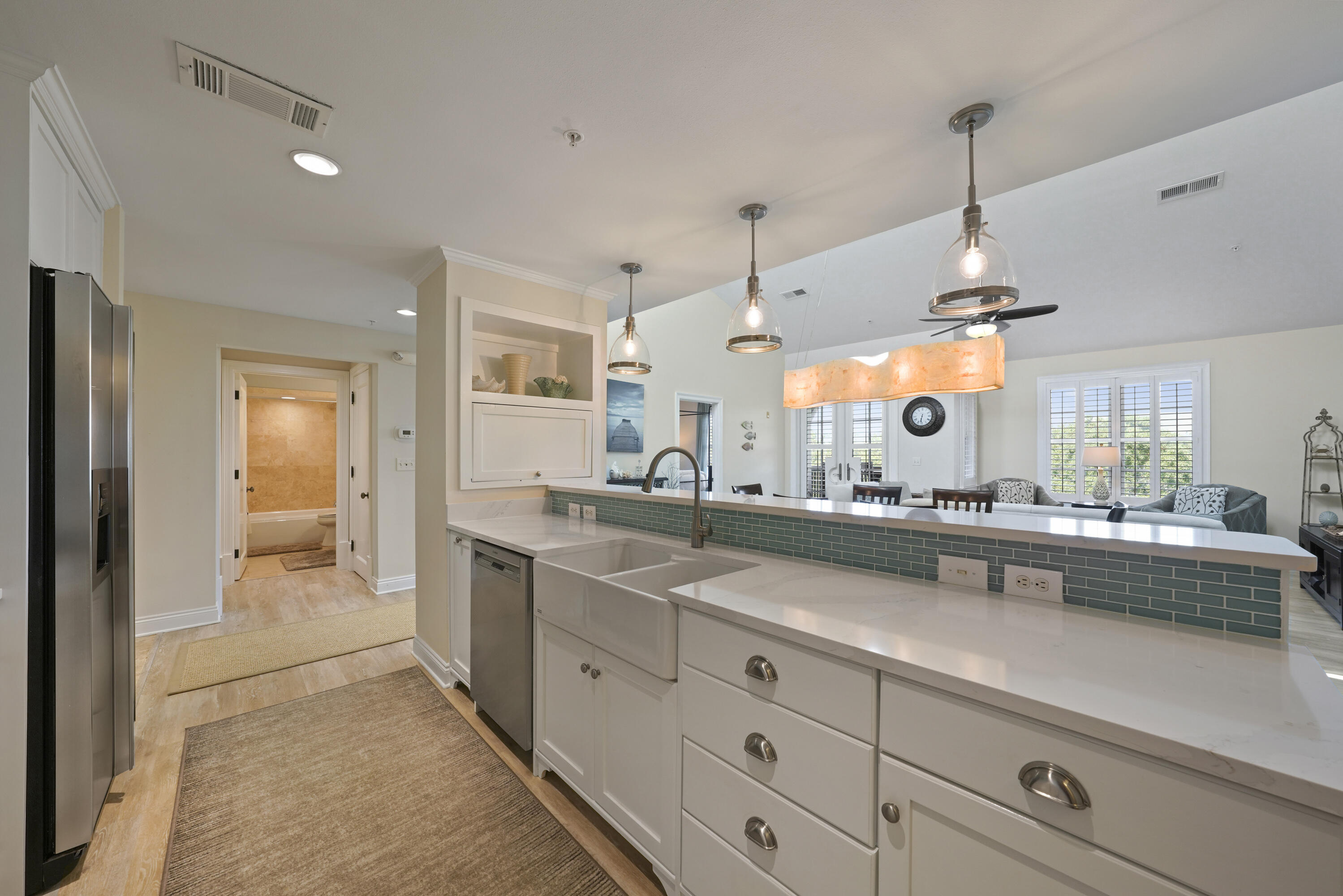34 North Barrett Square, Unit 3A Inlet Beach, FL 32461 - Photo 11 of 45 a large kitchen with kitchen island a large counter space a sink and stainless steel appliances