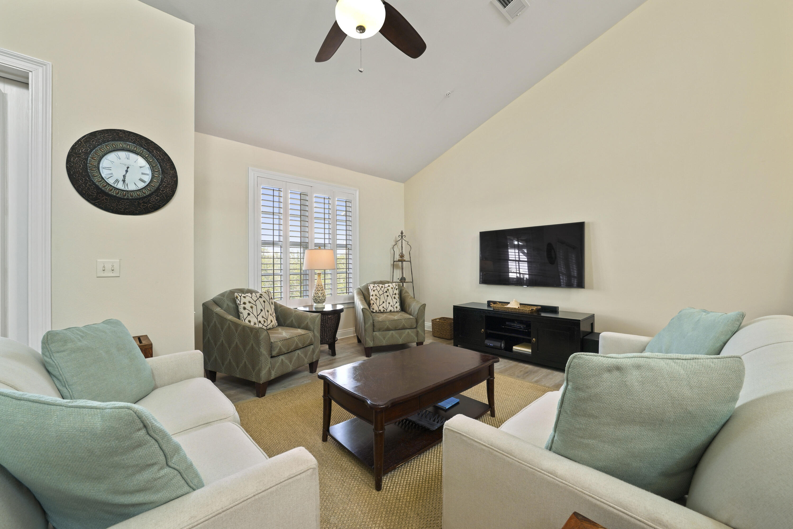 34 North Barrett Square, Unit 3A Inlet Beach, FL 32461 - Photo 14 of 45 a living room with furniture a flat screen tv and a window