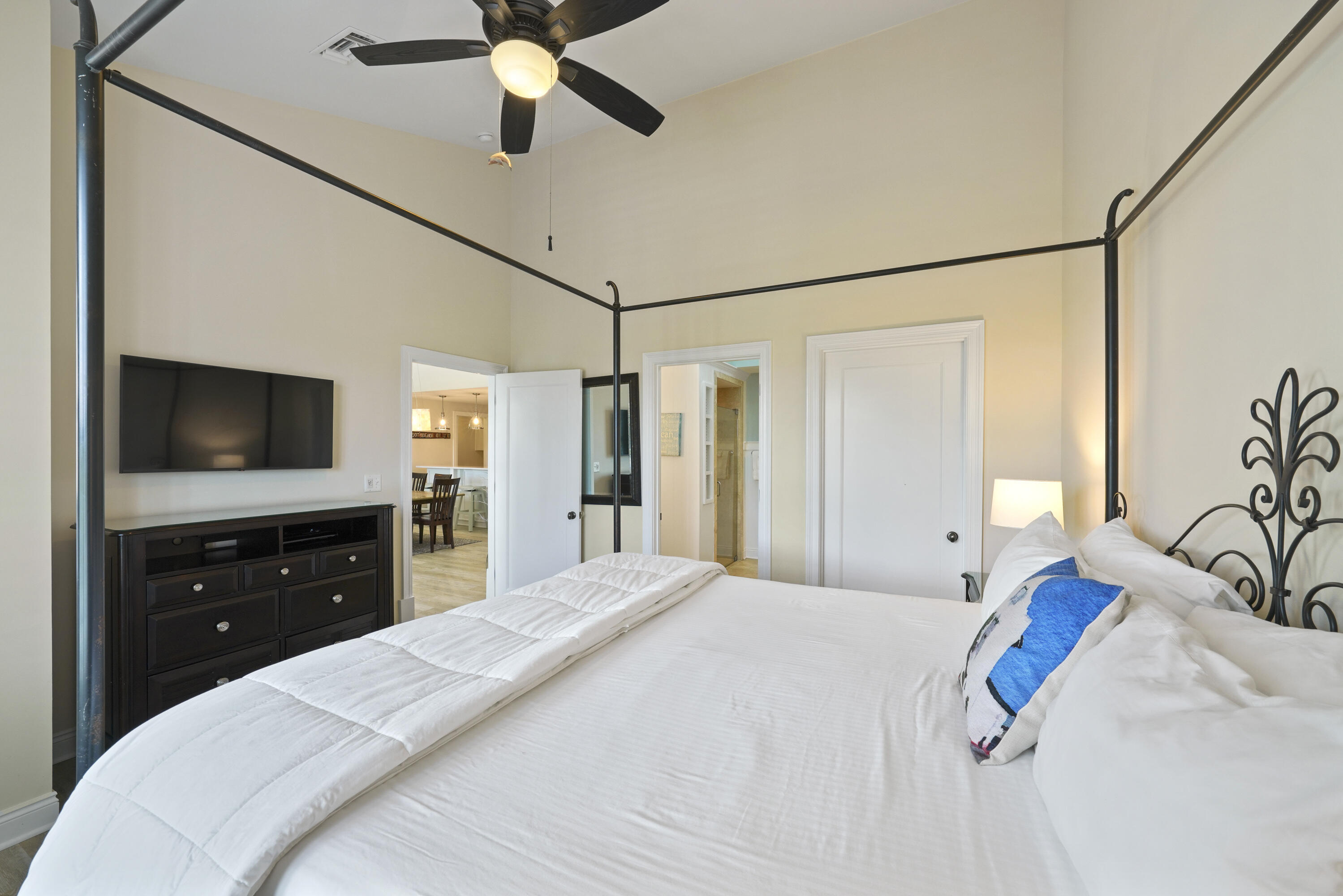 34 North Barrett Square, Unit 3A Inlet Beach, FL 32461 - Photo 20 of 45 a bedroom with a bed and a flat tv screen on dresser