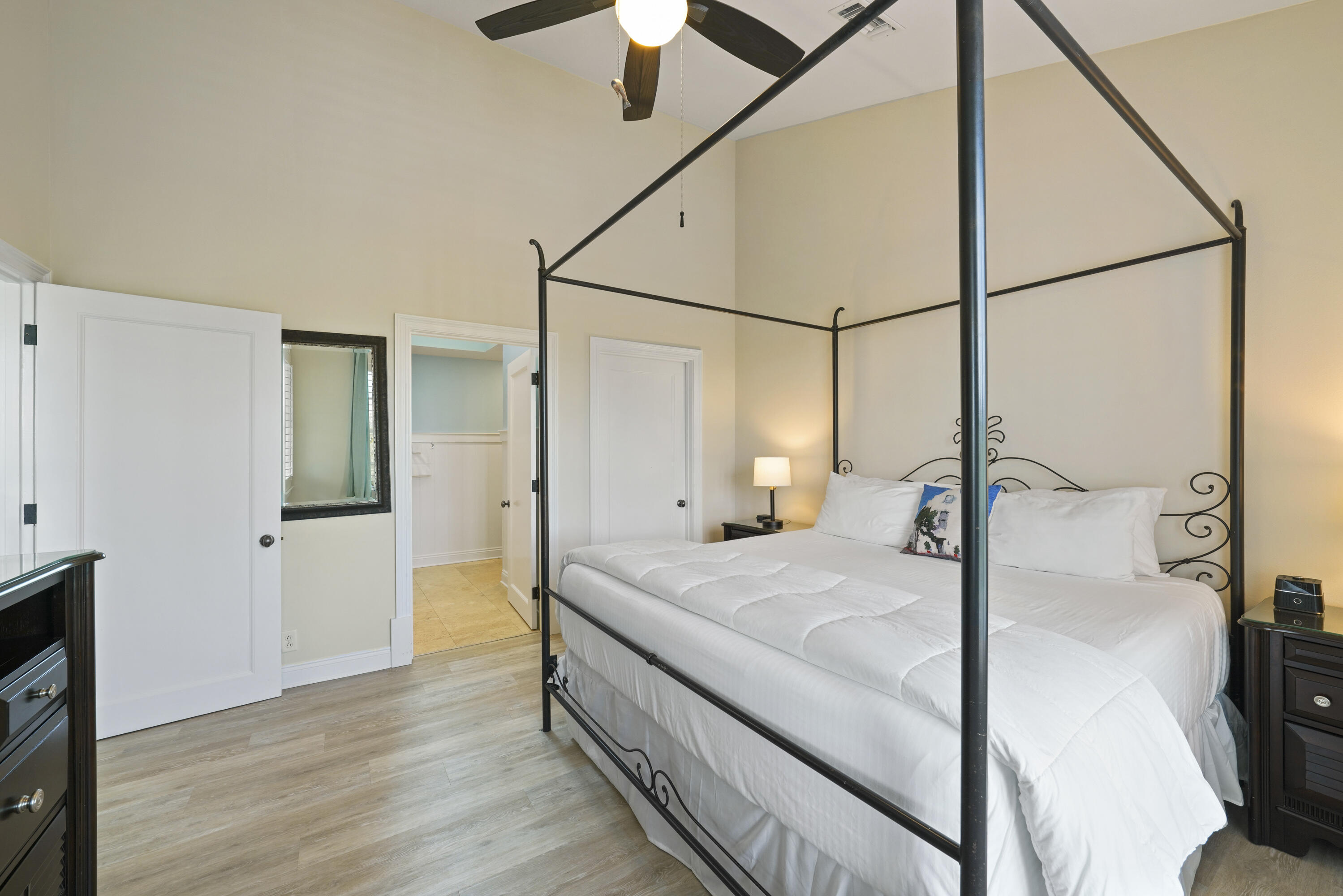 34 North Barrett Square, Unit 3A Inlet Beach, FL 32461 - Photo 21 of 45 a bedroom with a bed and a chandelier