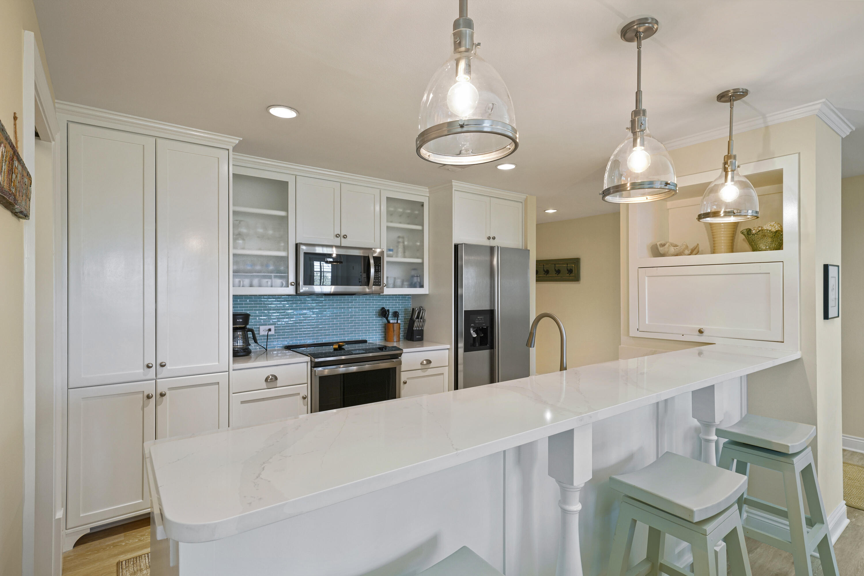 34 North Barrett Square, Unit 3A Inlet Beach, FL 32461 - Photo 3 of 45 a kitchen with stainless steel appliances a dining table chairs stove and cabinets