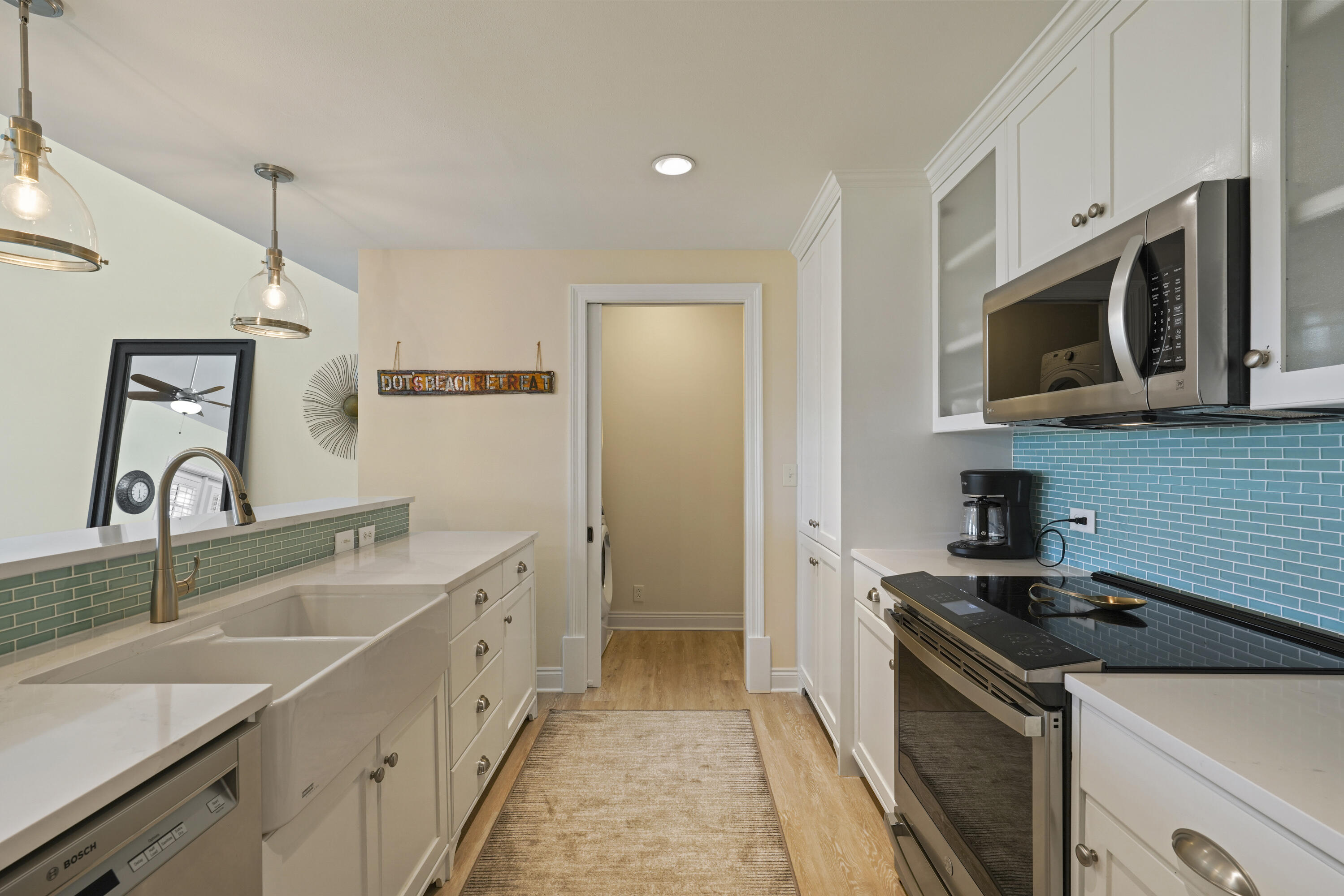 34 North Barrett Square, Unit 3A Inlet Beach, FL 32461 - Photo 8 of 45 a kitchen with a sink stove and microwave