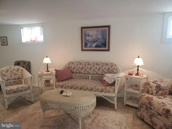 a living room with furniture a lamp and a window