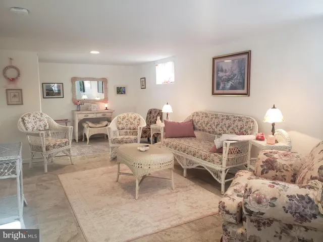 a living room with furniture and a lamp