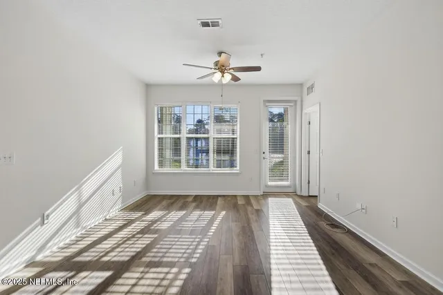 a view of a room with a window and a ceiling fan