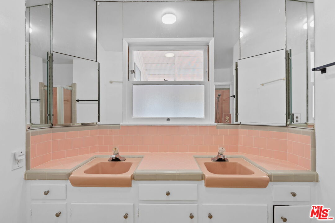 2485 Benedict Canyon Drive Beverly Hills, CA 90210 - Photo 19 of 33 a bathroom with a sink and a mirror