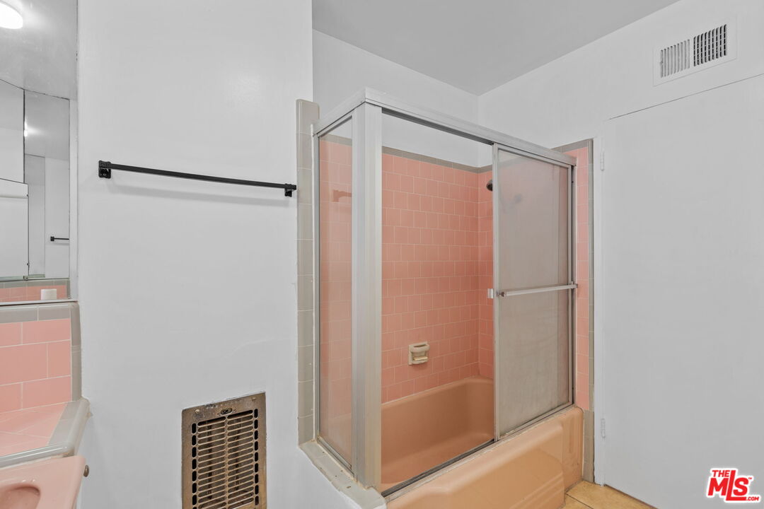 2485 Benedict Canyon Drive Beverly Hills, CA 90210 - Photo 20 of 33 a bathroom with a shower and a glass door