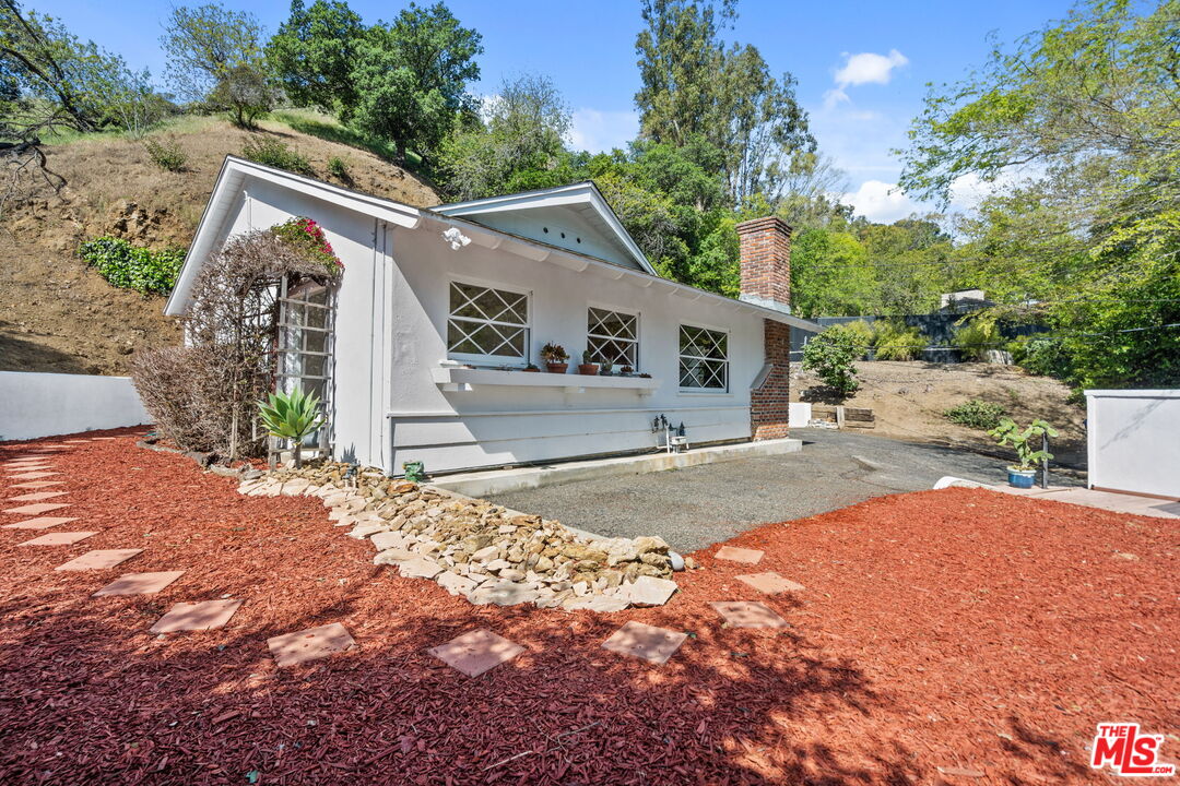 2485 Benedict Canyon Drive Beverly Hills, CA 90210 - Photo 2 of 33 a view of a house with a yard