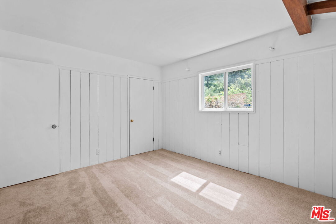 2485 Benedict Canyon Drive Beverly Hills, CA 90210 - Photo 24 of 33 an empty room with windows
