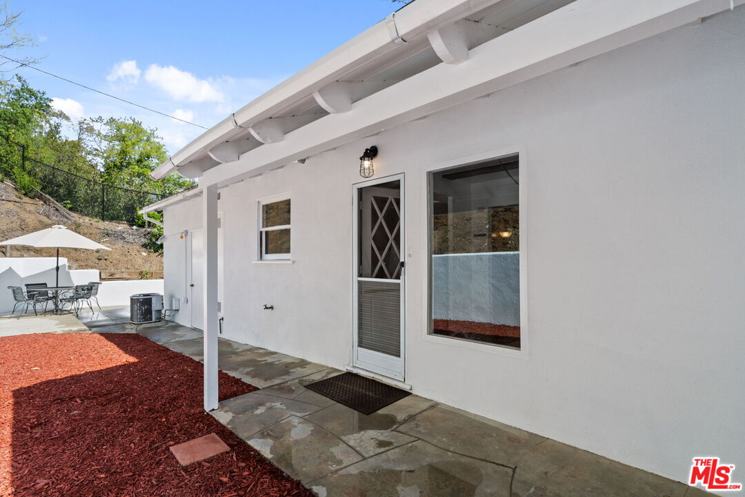 2485 Benedict Canyon Drive Beverly Hills, CA 90210 - Photo 25 of 33 a front view of a house with a porch