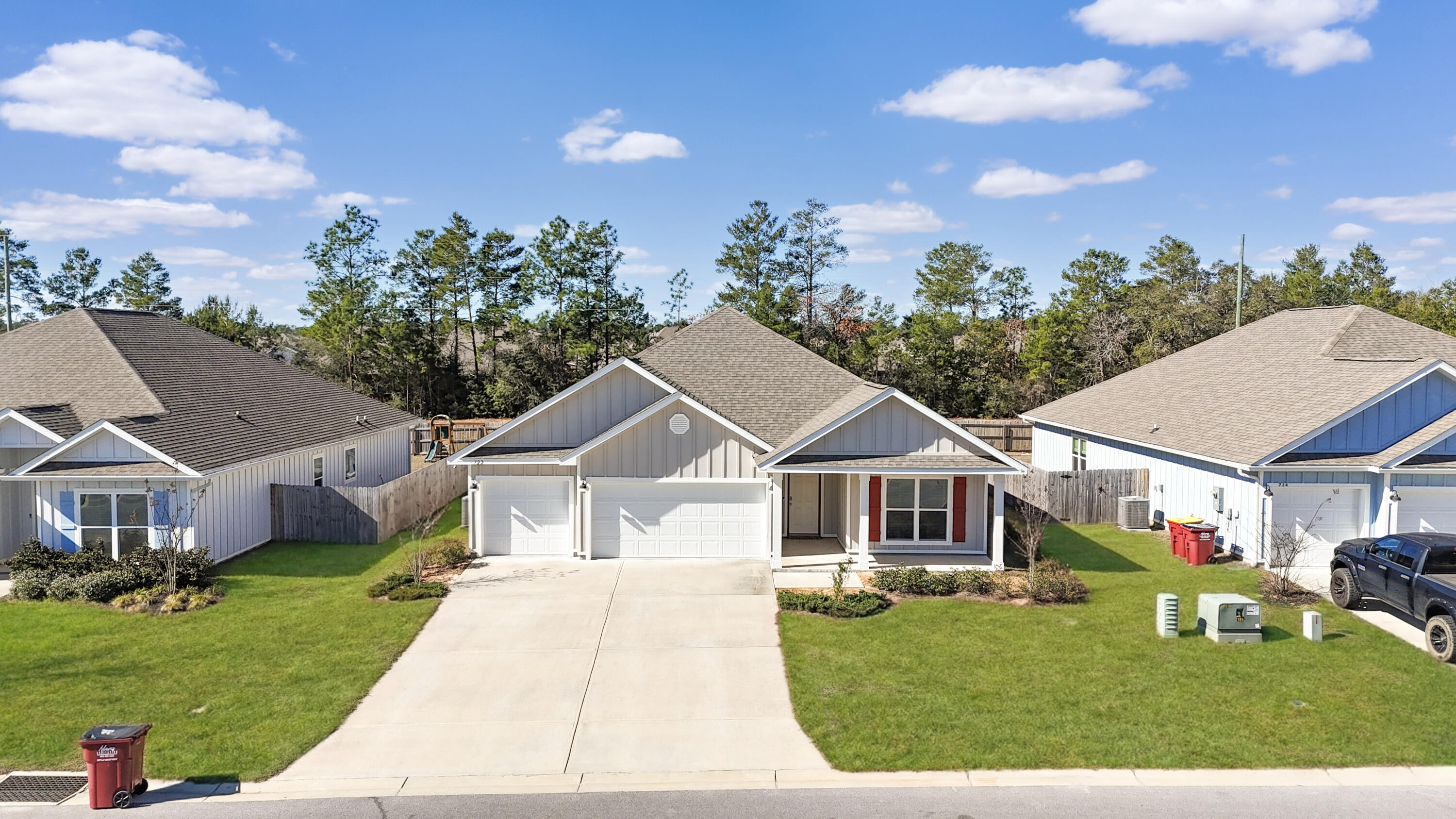 722 Quintana Street Crestview, FL 32539 - Photo 1 of 37 a front view of a house with a garden and trees