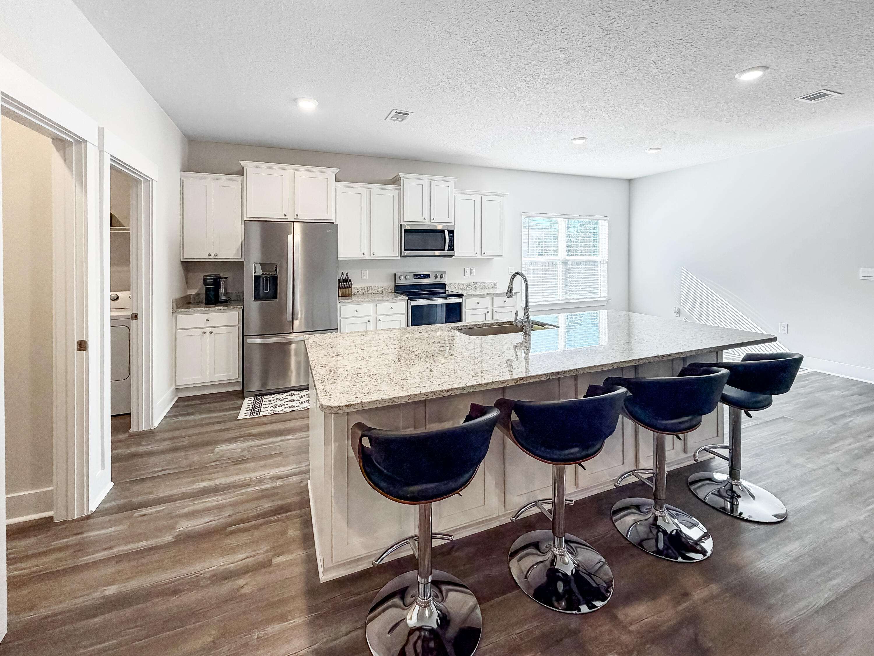 722 Quintana Street Crestview, FL 32539 - Photo 12 of 37 a kitchen with stainless steel appliances granite countertop a stove refrigerator and cabinets
