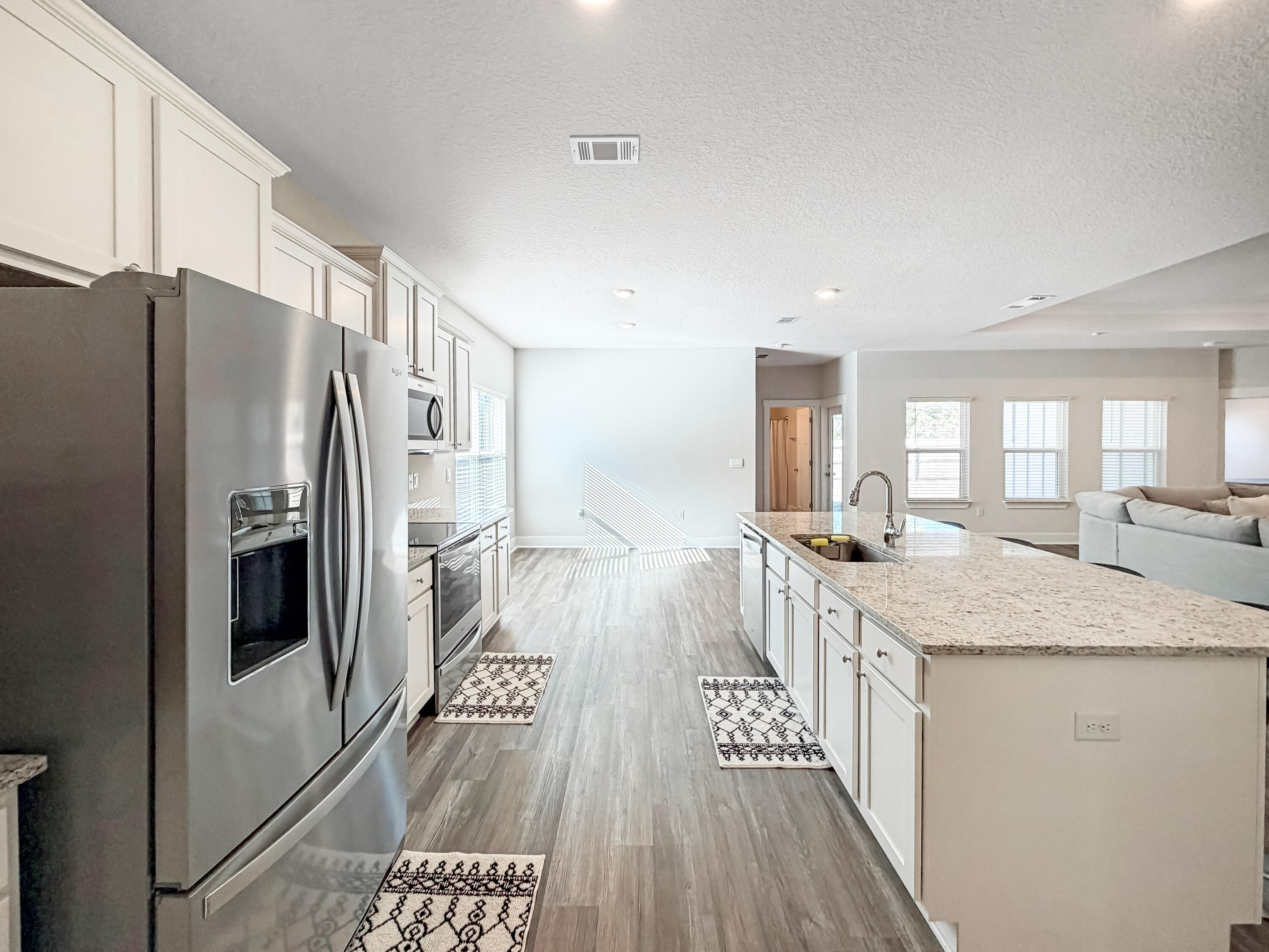 722 Quintana Street Crestview, FL 32539 - Photo 12 of 36 a kitchen with lot of cabinets and refrigerator