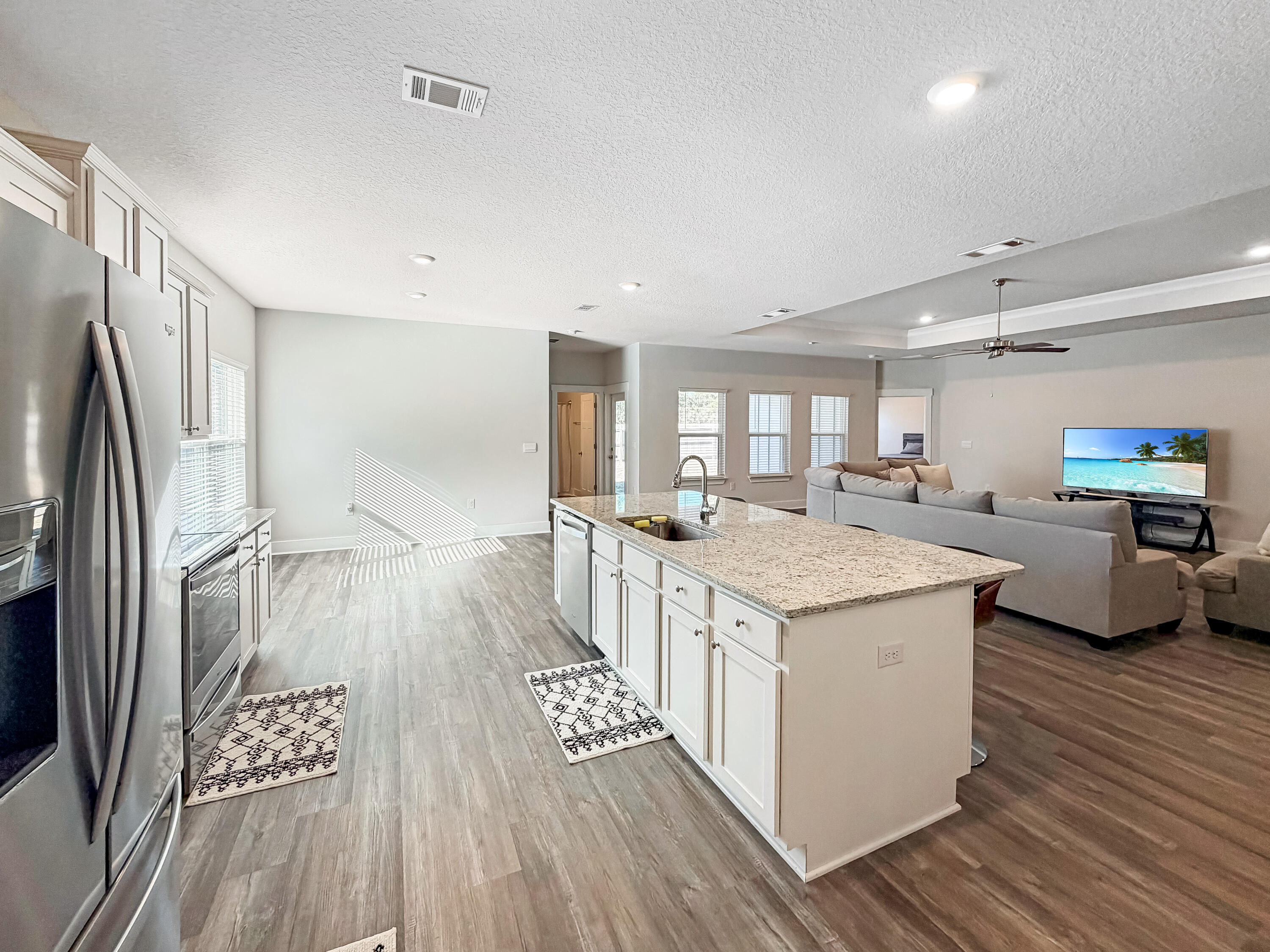 722 Quintana Street Crestview, FL 32539 - Photo 13 of 36 a kitchen with stainless steel appliances granite countertop a lot of counter top space and wooden floor