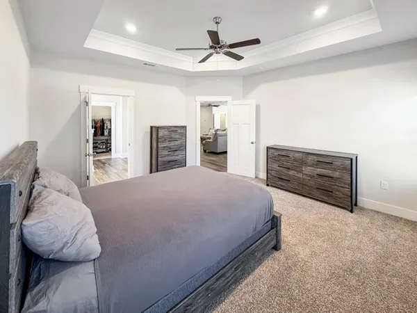 a spacious bedroom with a bed and a window