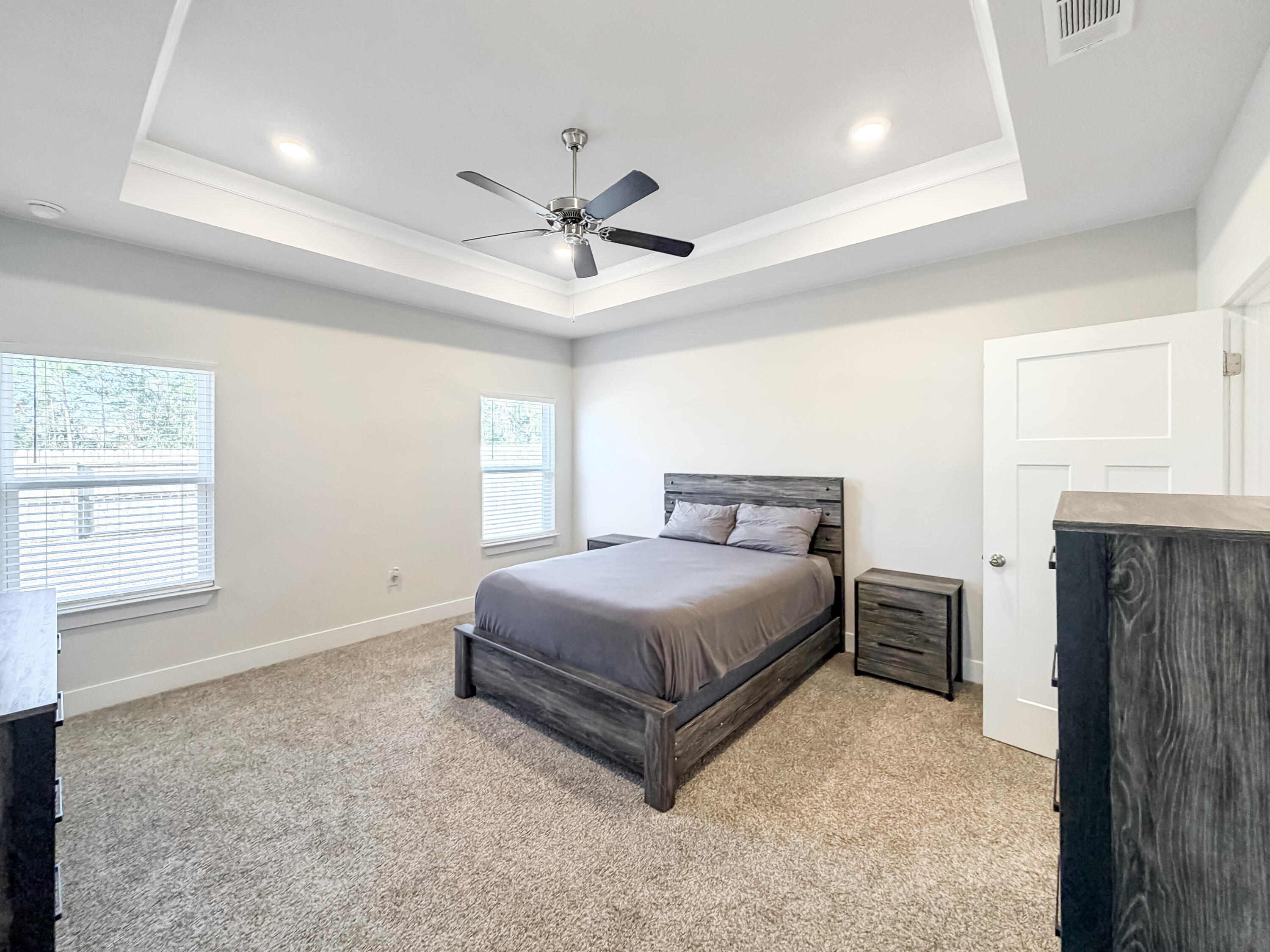 722 Quintana Street Crestview, FL 32539 - Photo 16 of 37 a spacious bedroom with a bed and a window
