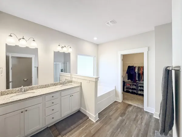 a bathroom with a double vanity sink and mirror