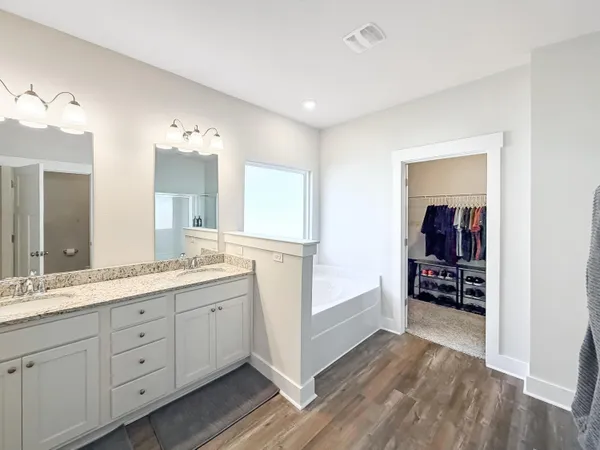 a bathroom with a bathtub and a sink