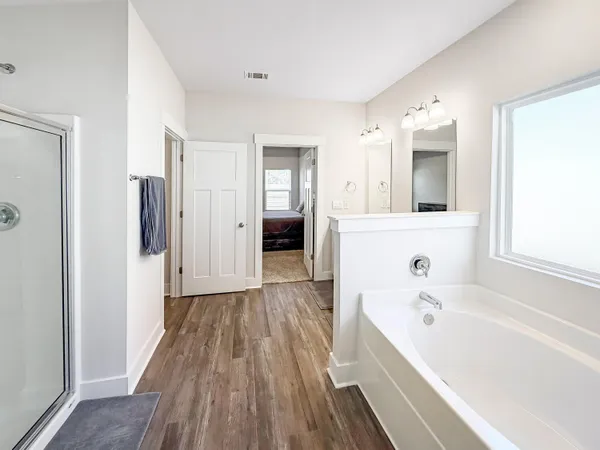 a view of a hallway with wooden floor and a sink