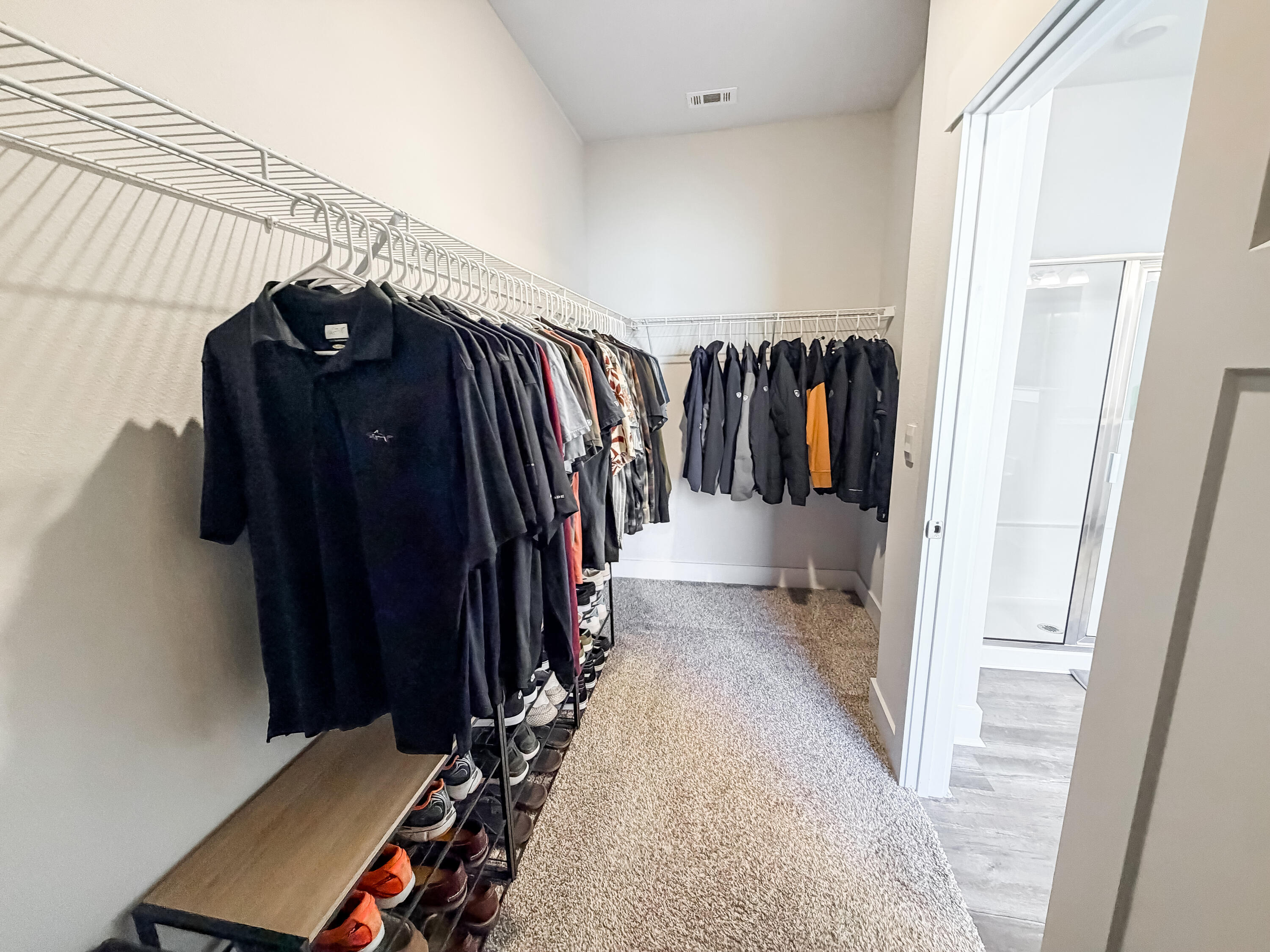 722 Quintana Street Crestview, FL 32539 - Photo 23 of 37 a view of walk in closet with clothes