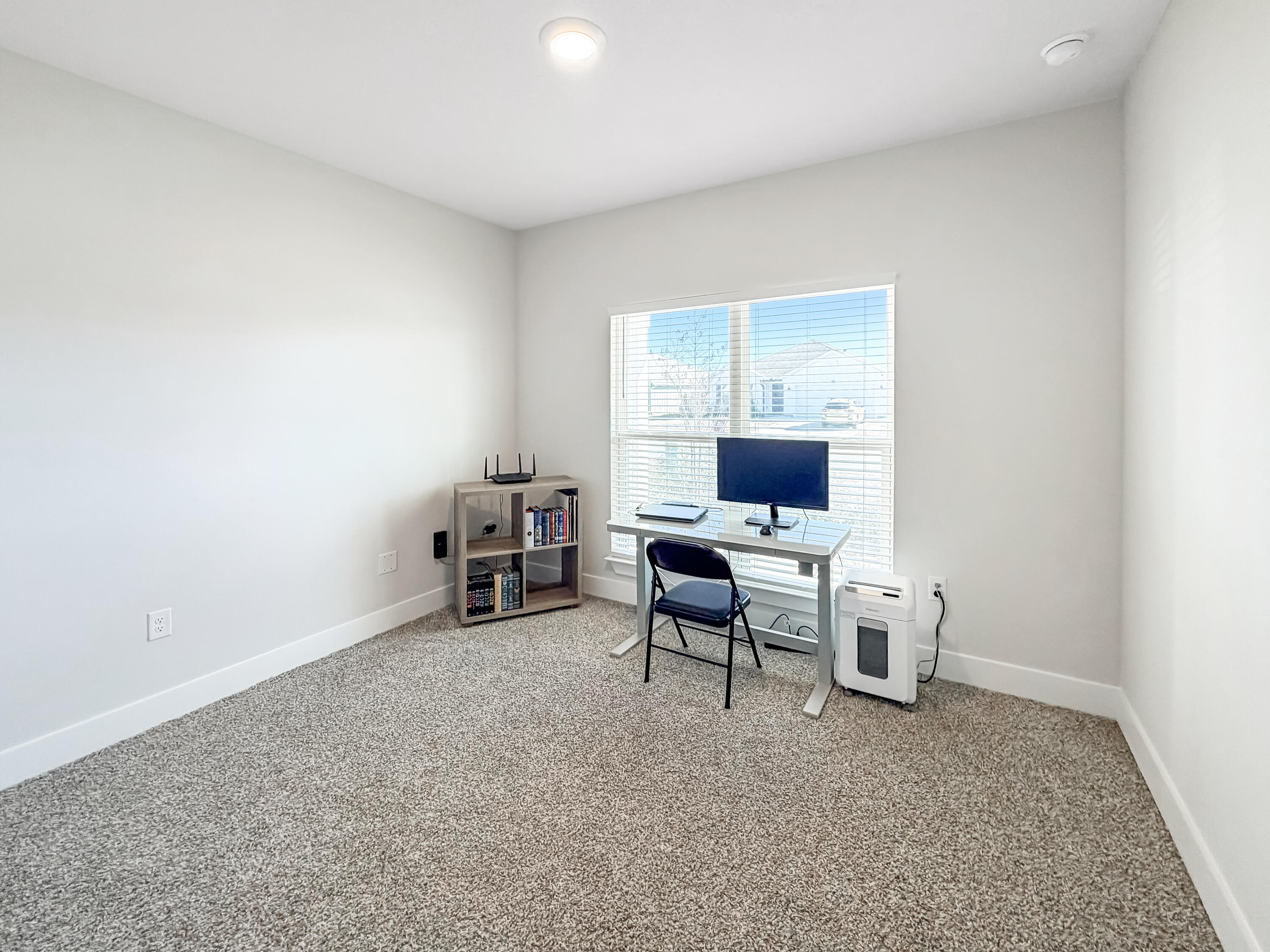 722 Quintana Street Crestview, FL 32539 - Photo 24 of 37 a view of a workspace with furniture and a window
