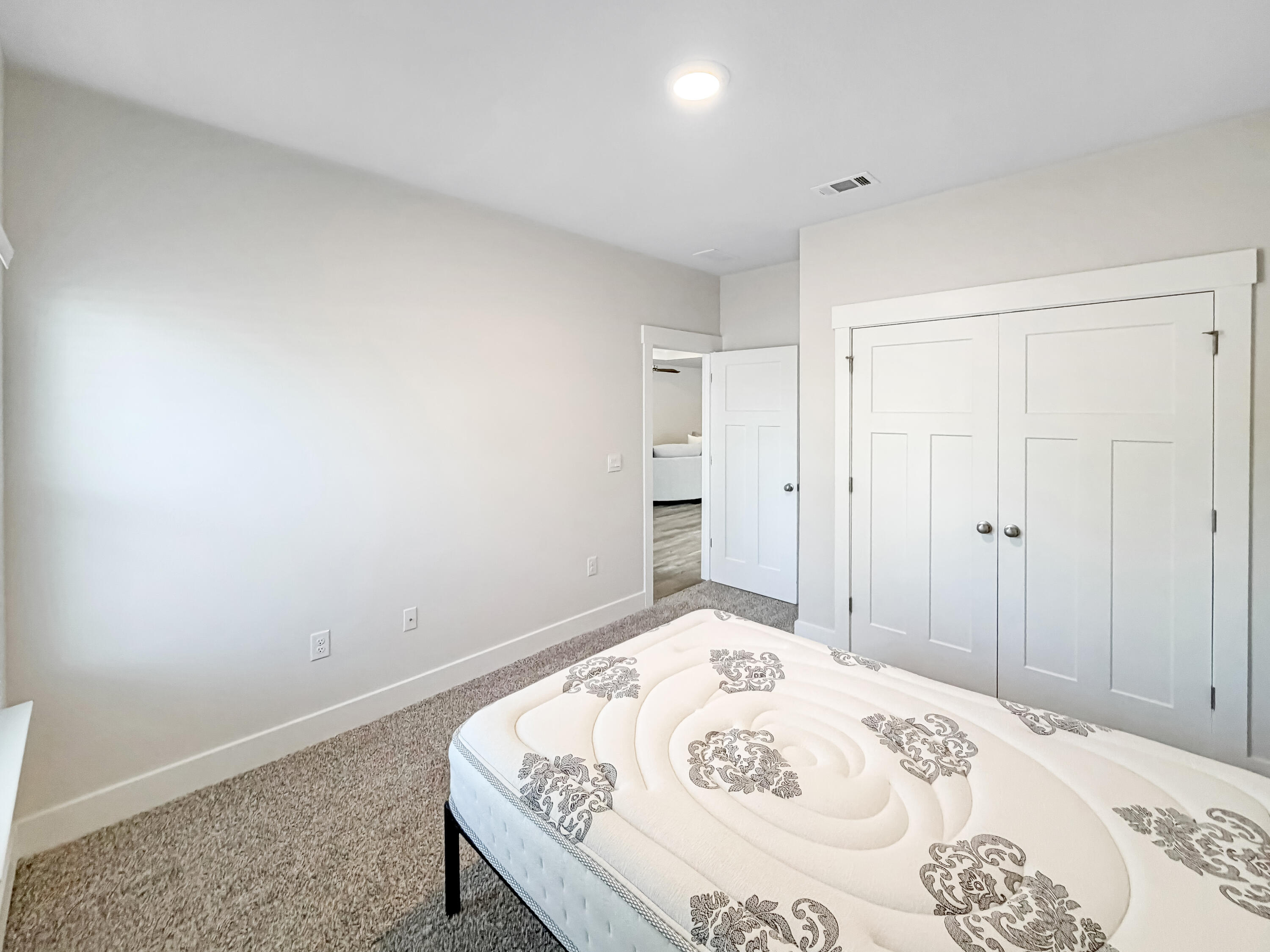 722 Quintana Street Crestview, FL 32539 - Photo 27 of 37 a bedroom with a bed and a dresser