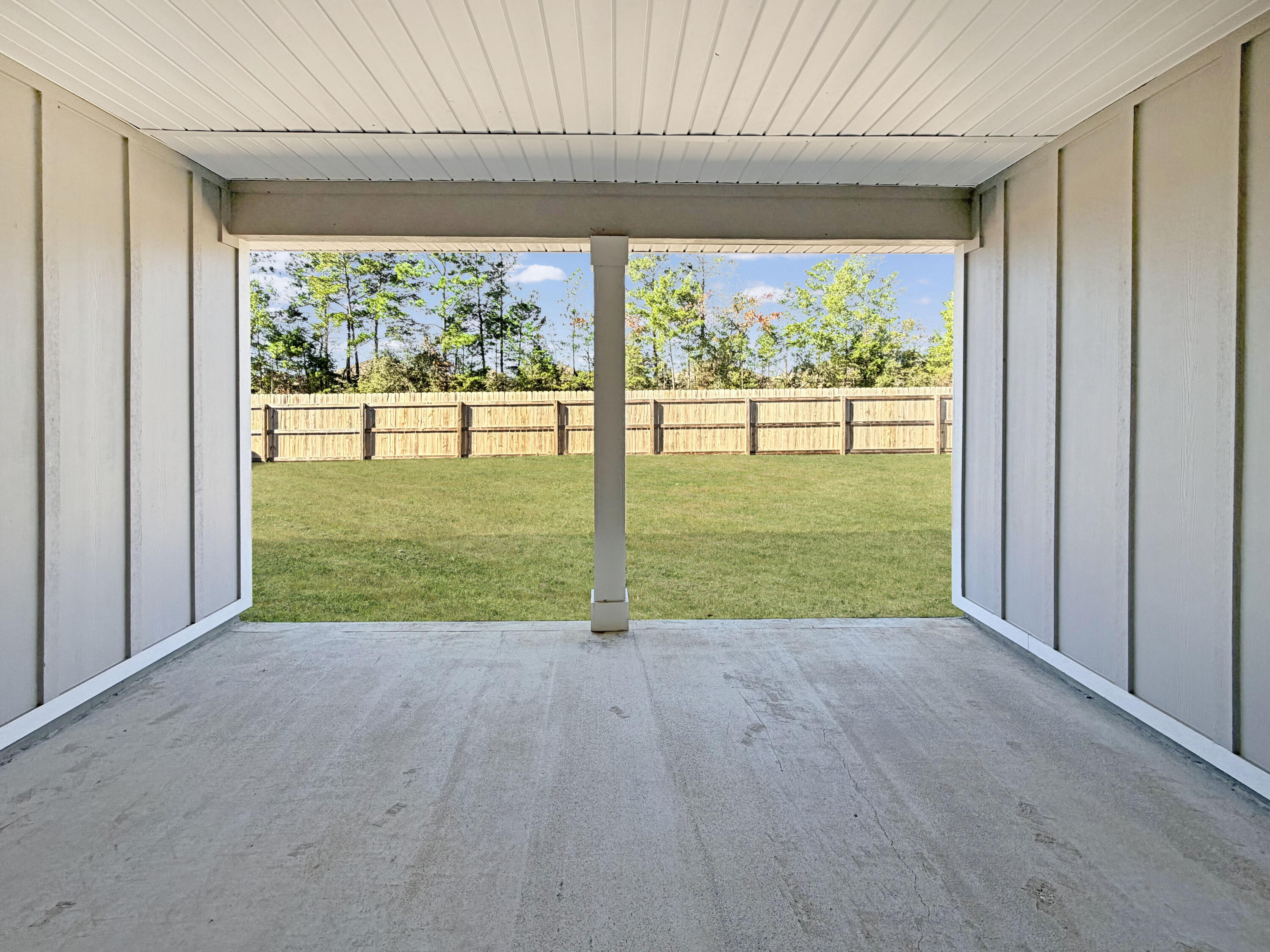 722 Quintana Street Crestview, FL 32539 - Photo 30 of 36 an empty room with yard and a floor to ceiling window