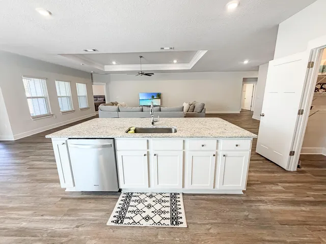 a view of a kitchen with a sink a counter top space and appliances