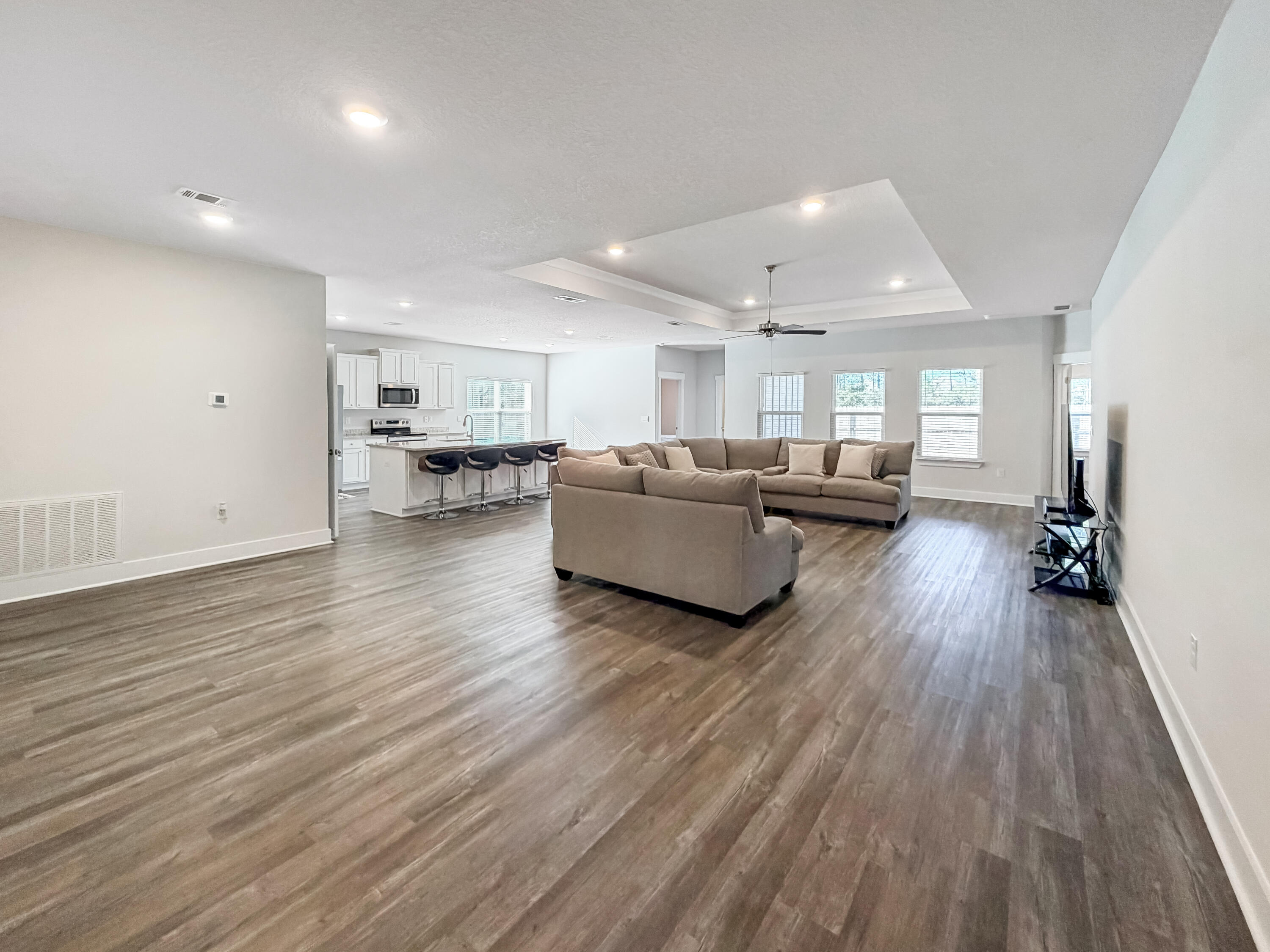 722 Quintana Street Crestview, FL 32539 - Photo 4 of 36 a living room with furniture and a wooden floor