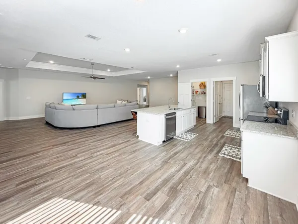 a living room with furniture and a wooden floor