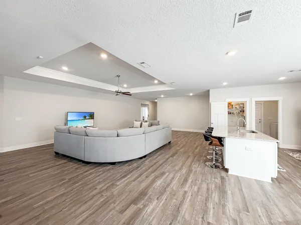 a living room with a couch and a wooden floor